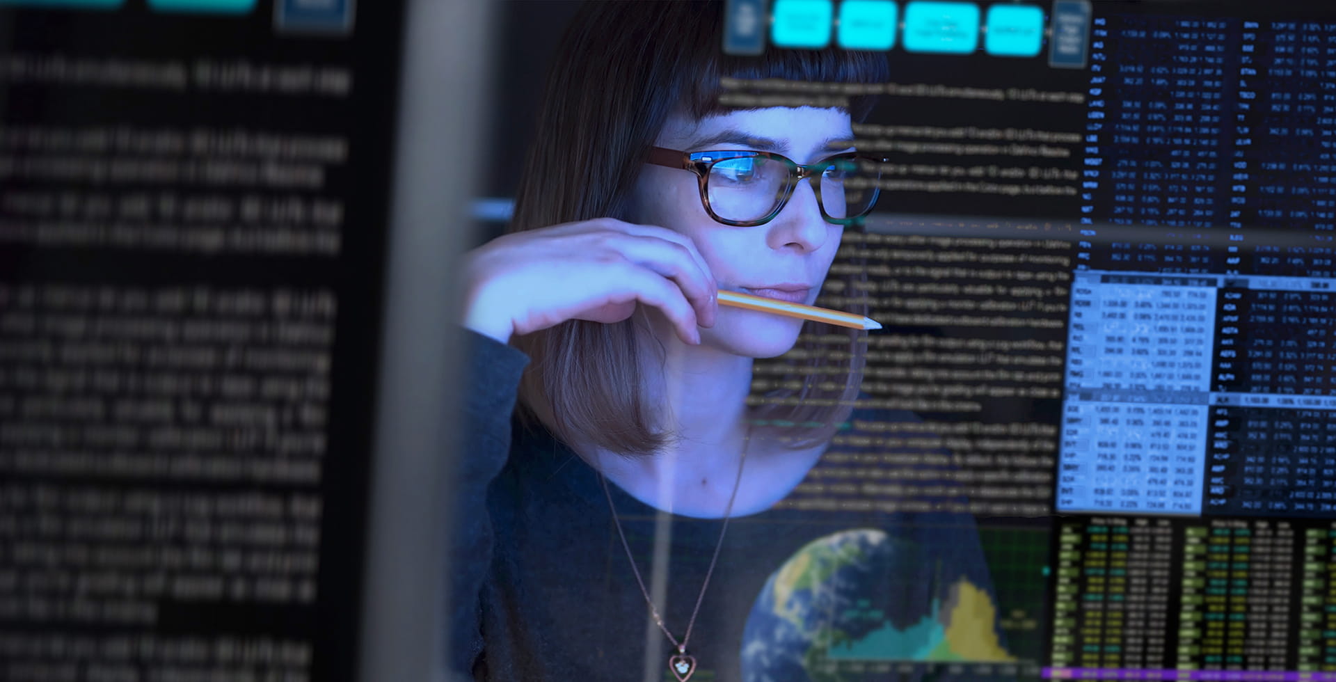 woman watching multiple monitors